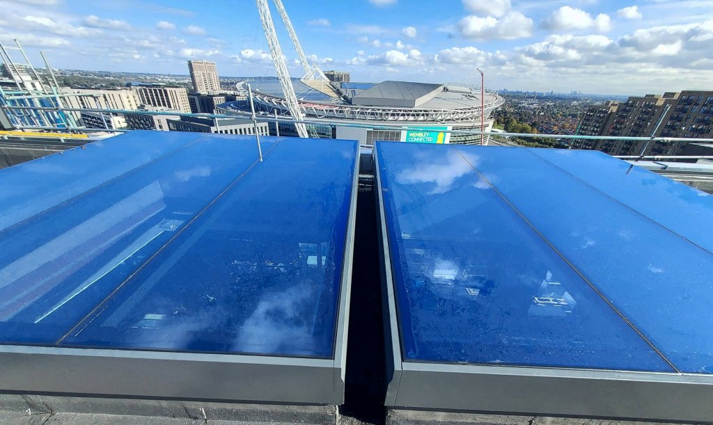 two rooflights installed on a high rooftop opposite Wembley Stadium